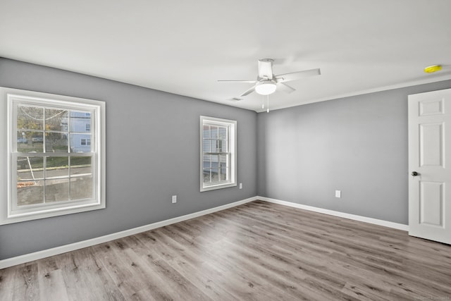 spare room with ceiling fan and hardwood / wood-style flooring