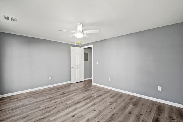 empty room with crown molding, ceiling fan, and light wood-type flooring