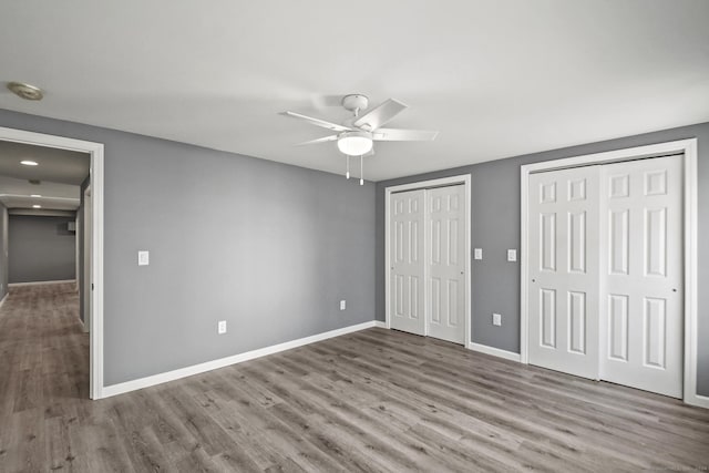 172 Quinnipiac Ave, New Haven, CT 06513 - unfurnished bedroom featuring multiple closets, wood finished floors, and ceiling fan