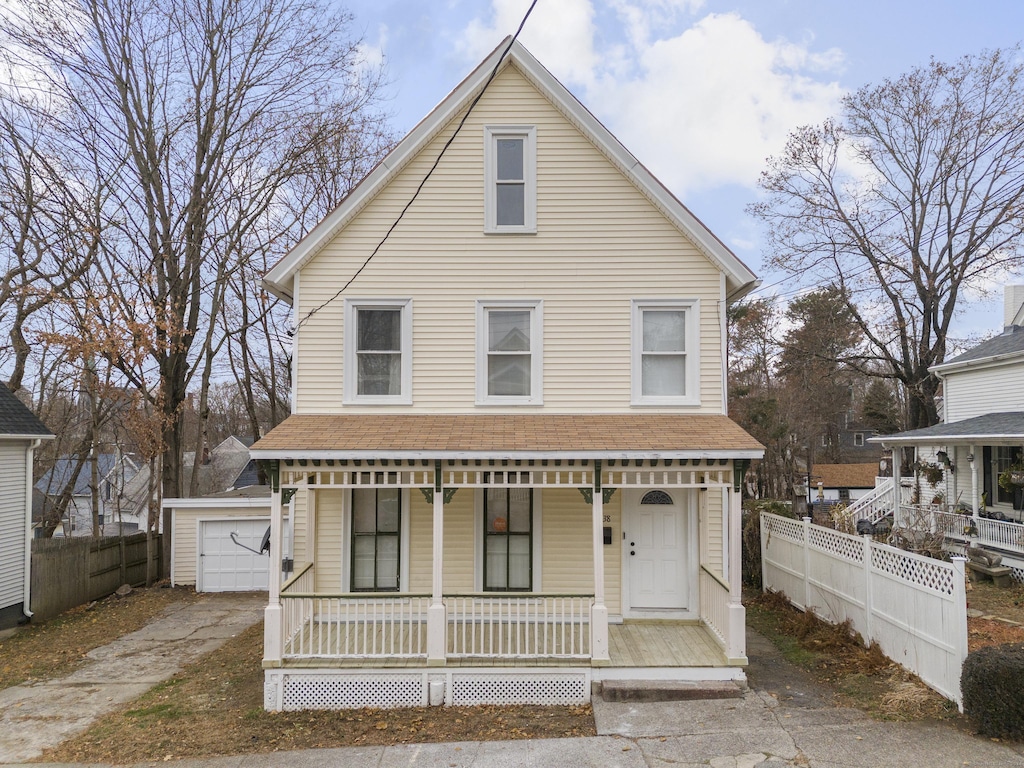 view of front of home with a porch, an outdoor structure, and a garage