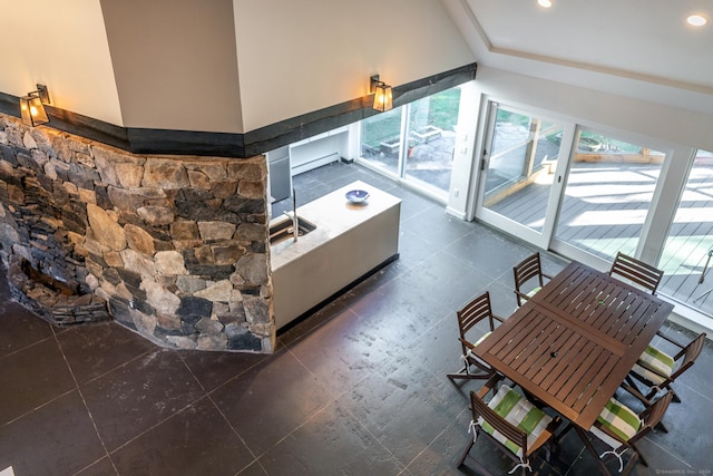 living room with vaulted ceiling and dark tile patterned floors