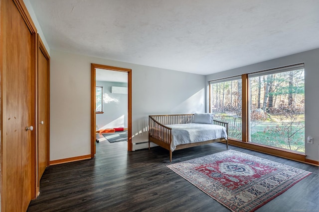 bedroom featuring dark wood-type flooring and a textured ceiling