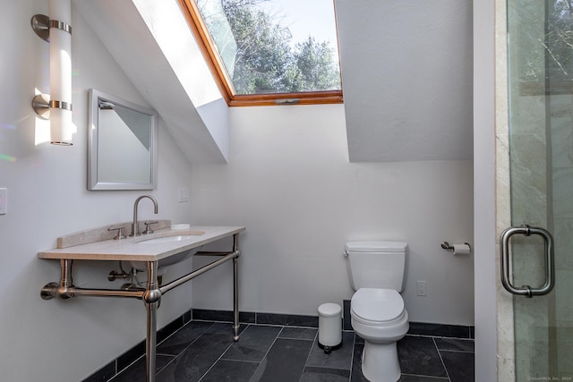 bathroom featuring tile patterned floors, an enclosed shower, lofted ceiling with skylight, sink, and toilet