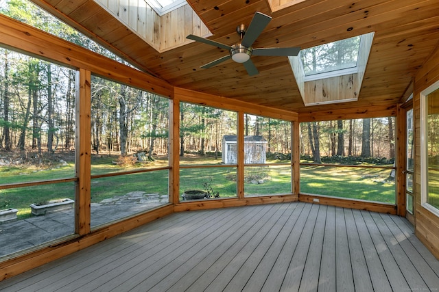 unfurnished sunroom with ceiling fan, wood ceiling, and lofted ceiling with skylight