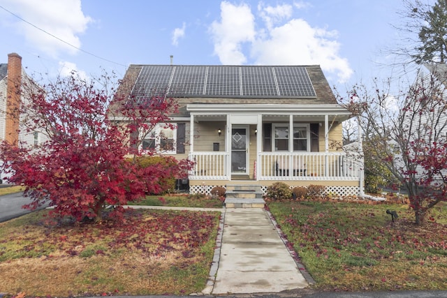 bungalow-style home featuring covered porch and solar panels