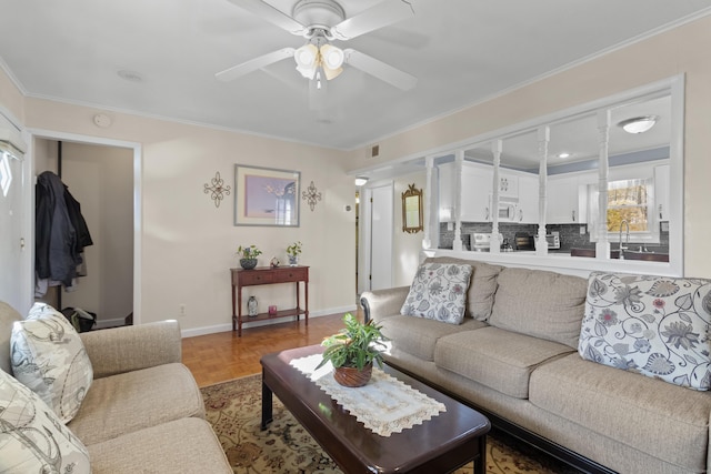 living room featuring crown molding, sink, ceiling fan, and hardwood / wood-style flooring