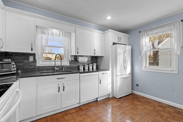 kitchen featuring backsplash, white appliances, dark parquet floors, sink, and white cabinetry