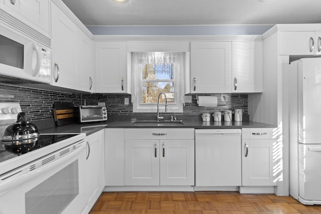 kitchen featuring decorative backsplash, a textured ceiling, white appliances, sink, and white cabinets