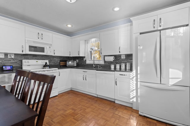 kitchen featuring white cabinetry, sink, backsplash, light parquet floors, and white appliances