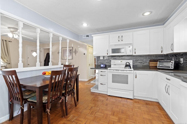 kitchen featuring white cabinets, ceiling fan, white appliances, and tasteful backsplash