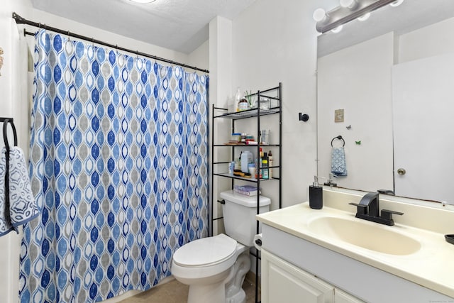 bathroom featuring tile patterned flooring, a textured ceiling, vanity, and toilet