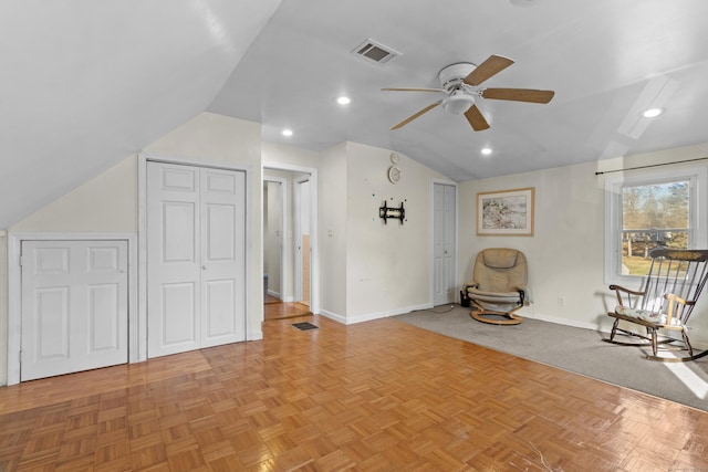 unfurnished room featuring light parquet flooring, vaulted ceiling, and ceiling fan