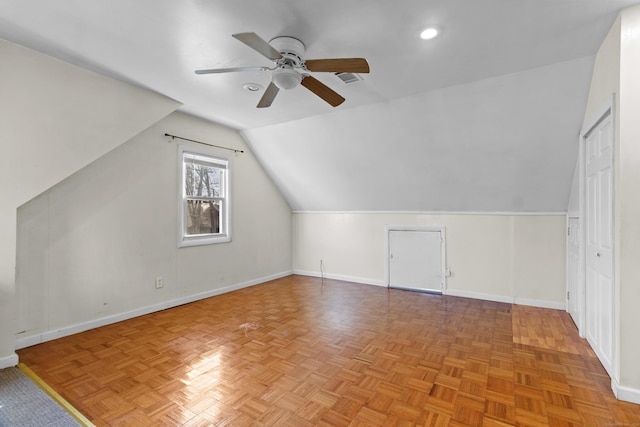 additional living space with ceiling fan, light parquet floors, and lofted ceiling