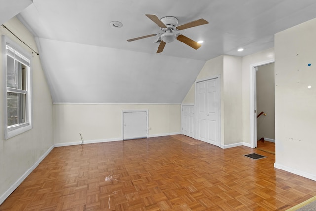 bonus room with ceiling fan, light parquet flooring, and lofted ceiling