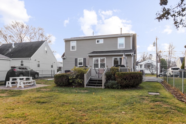 back of house featuring a yard and a wooden deck