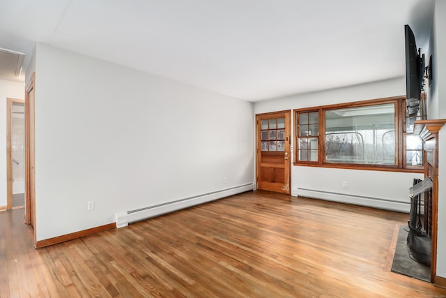 unfurnished living room with light wood-type flooring and baseboard heating