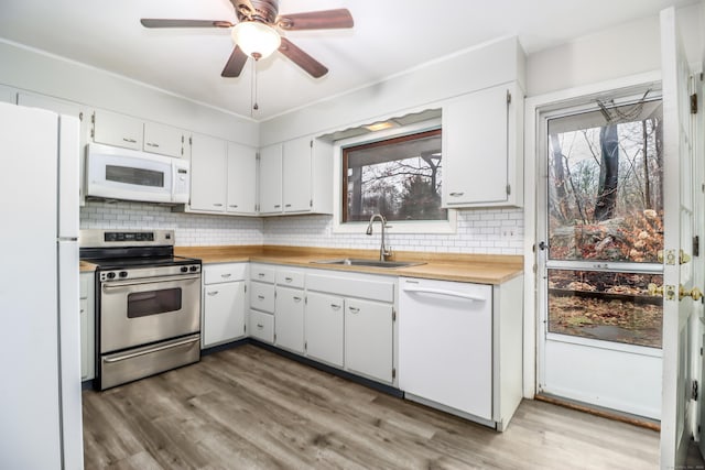 kitchen with sink, white cabinets, white appliances, and decorative backsplash