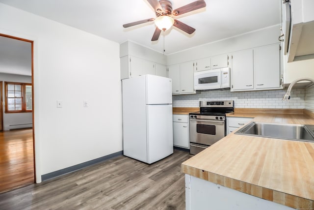 kitchen with sink, white cabinetry, tasteful backsplash, baseboard heating, and white appliances