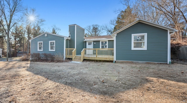 back of house featuring a wooden deck