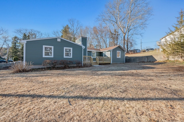 back of house featuring a yard and a deck