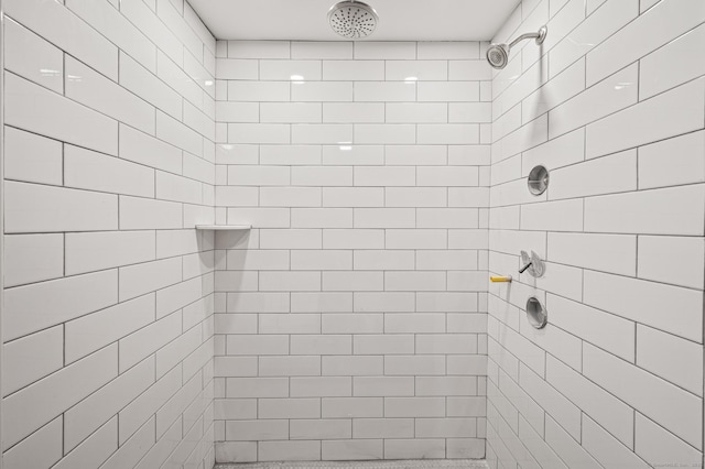 bathroom with a tile shower