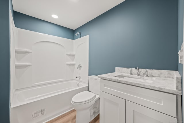 full bathroom featuring vanity, hardwood / wood-style flooring, toilet, and shower / bathtub combination