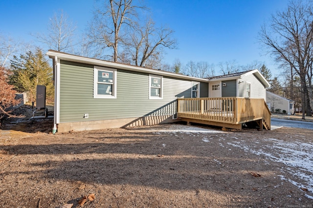 rear view of house featuring a wooden deck