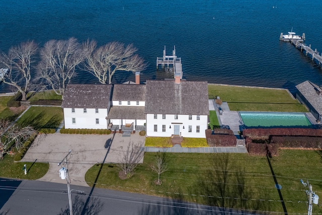 birds eye view of property with a water view