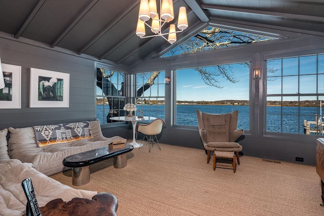 sunroom with a water view, visible vents, lofted ceiling with beams, and an inviting chandelier