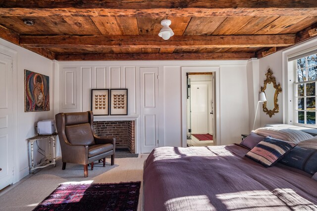 bedroom featuring wooden ceiling, light carpet, and beamed ceiling