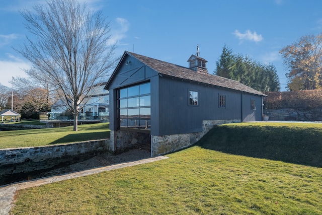 view of side of property with a yard and a chimney