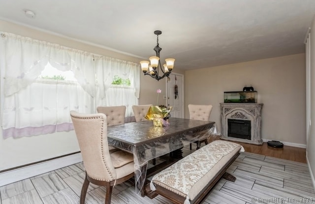 dining area with light hardwood / wood-style flooring and a chandelier