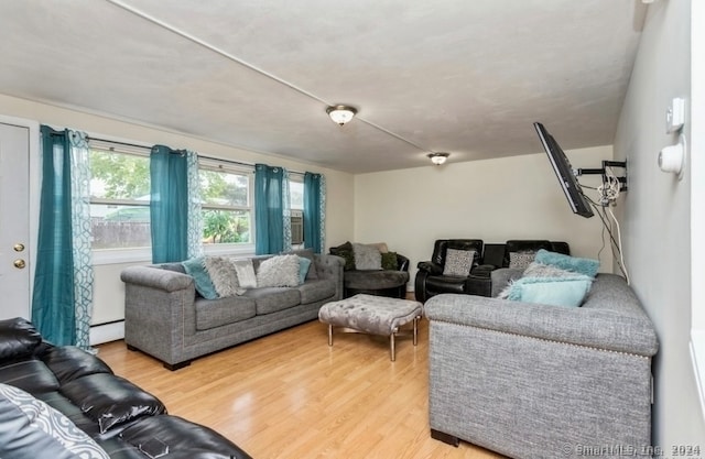 living room with hardwood / wood-style flooring and baseboard heating