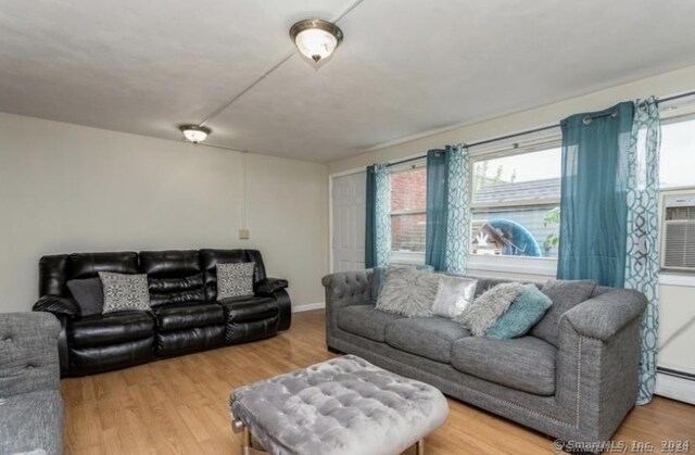 25 Liberty St Unit E, New Haven, CT 06519 - living room with wood finished floors and a baseboard heating unit