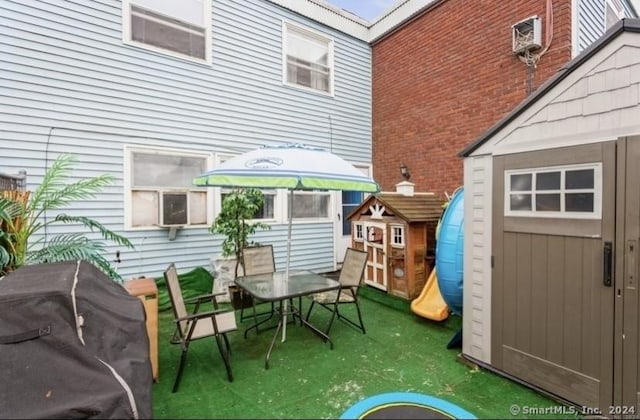 25 Liberty St Unit E, New Haven, CT 06519 - view of patio / terrace with a shed, area for grilling, and outdoor dining space