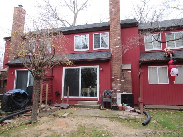 back of house featuring central AC