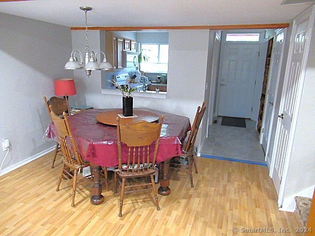 dining area featuring light hardwood / wood-style flooring and an inviting chandelier