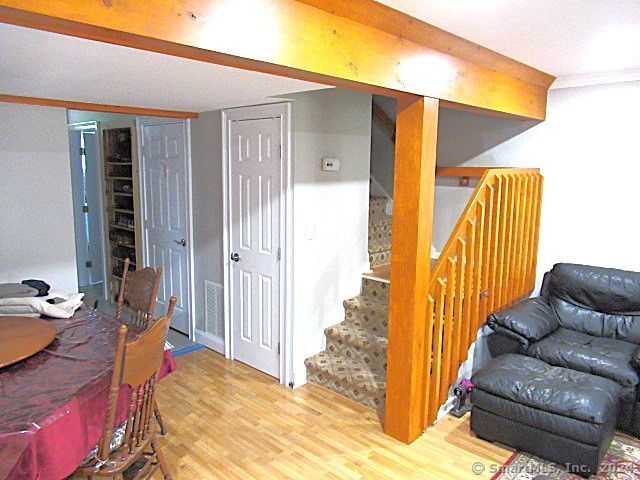 basement featuring crown molding and wood-type flooring