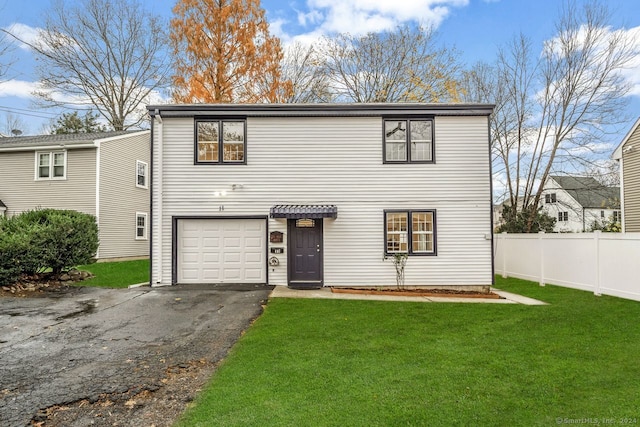 view of front of house with a garage and a front yard