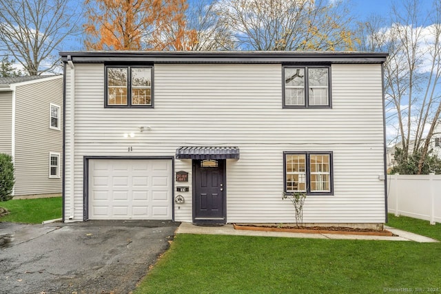 view of front of home with a garage and a front yard