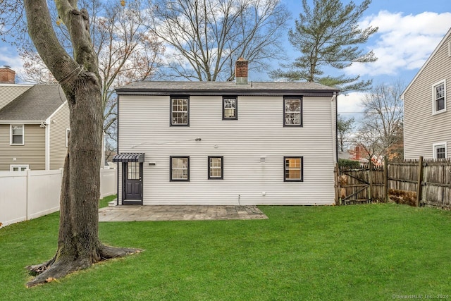 back of property featuring a lawn and a patio area