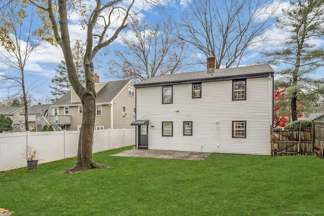 back of property featuring a lawn and a patio area