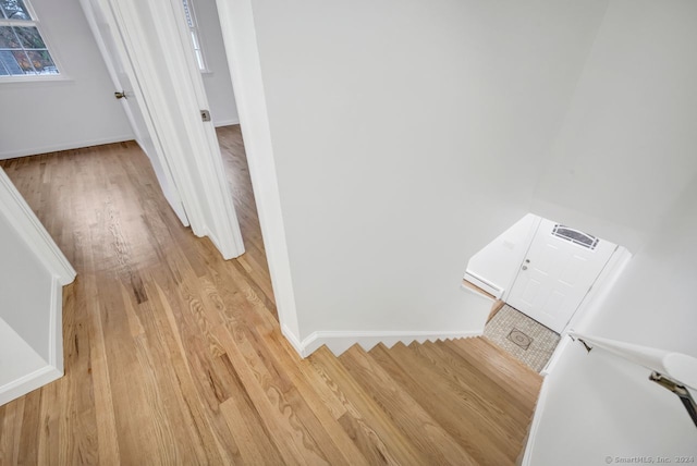 staircase with wood-type flooring