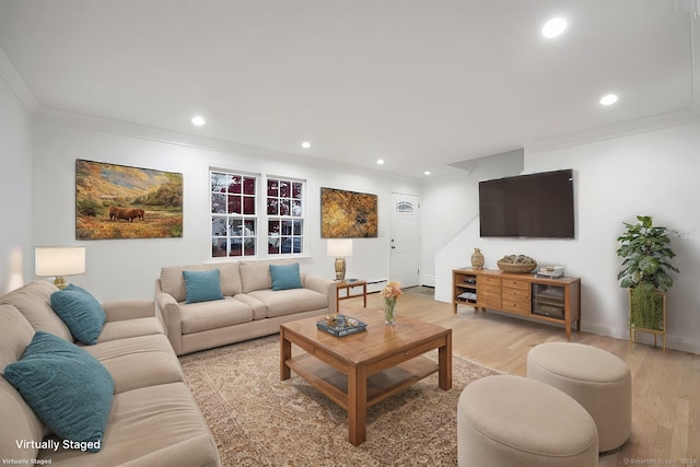 living room with light hardwood / wood-style flooring and ornamental molding