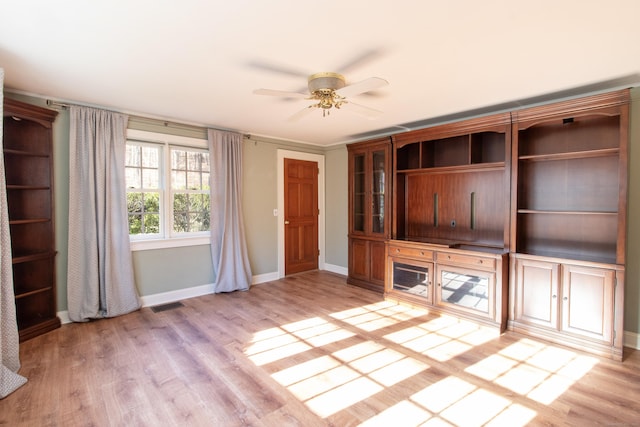 unfurnished living room featuring baseboards, a ceiling fan, light wood-style flooring, and visible vents