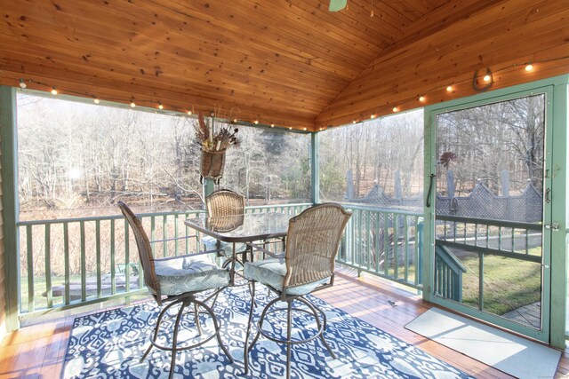 unfurnished sunroom featuring wooden ceiling and vaulted ceiling