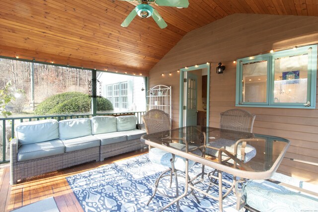 sunroom with ceiling fan, wooden ceiling, and lofted ceiling