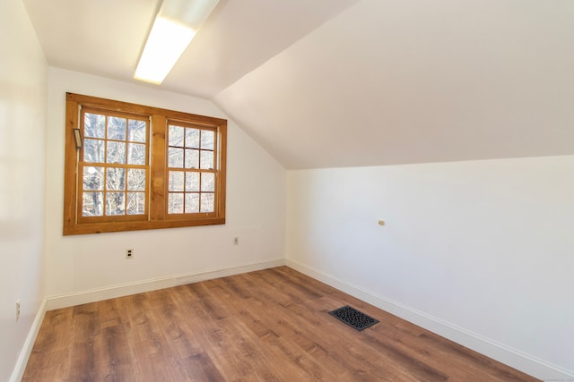 bonus room featuring hardwood / wood-style floors and vaulted ceiling