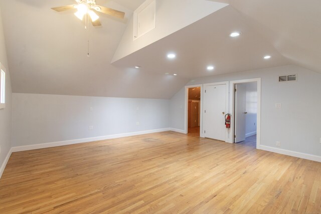 bonus room with ceiling fan, lofted ceiling, and light wood-type flooring