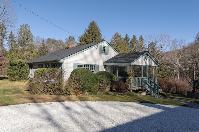 ranch-style home featuring covered porch and a chimney